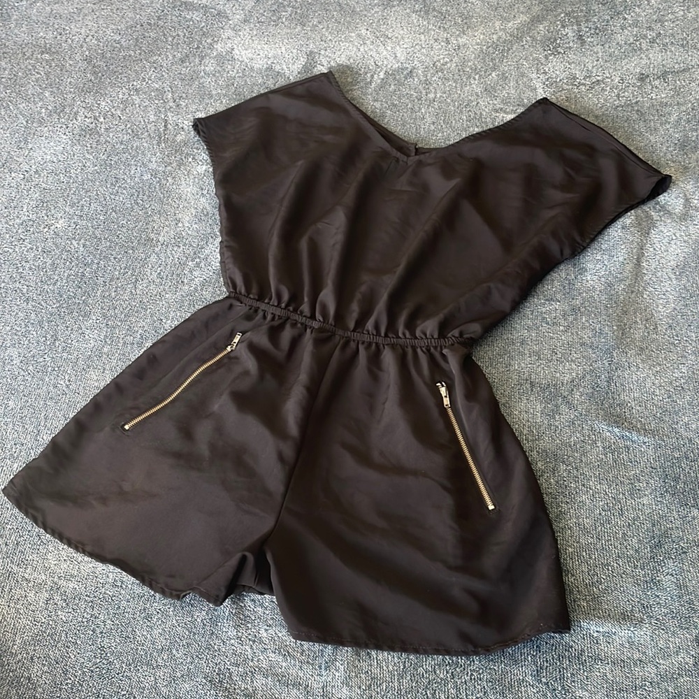 Medium Black Romper with zipper pockets and button back.